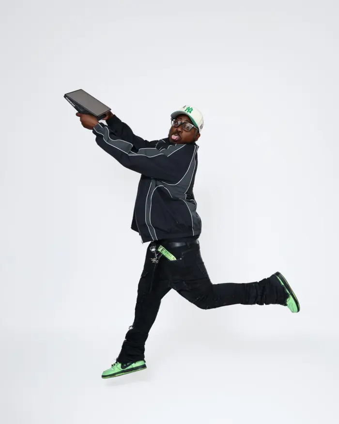 DJ Swiizzy jumping with his laptop